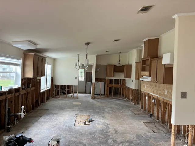 a living room with lots of furniture and a view of kitchen