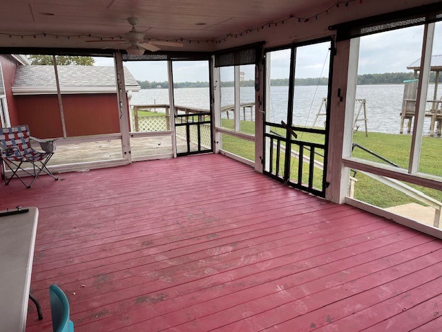 12 Walnut Bend Huntsville, TX 77320 - Photo 10 of 16 a view of a porch with wooden floor and floor to ceiling window