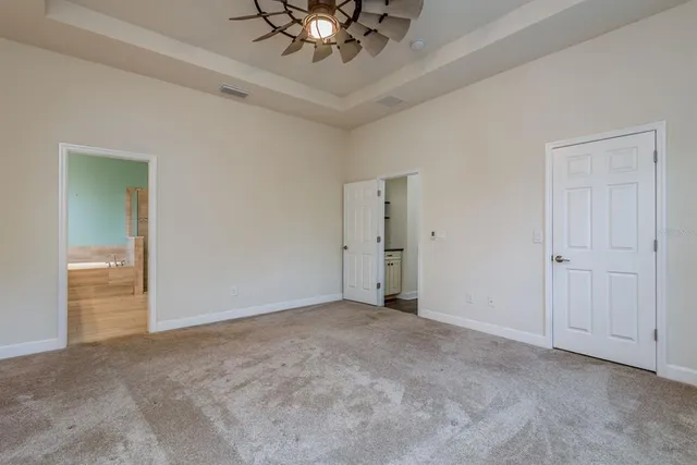 a bathroom with a granite countertop sink and a large mirror