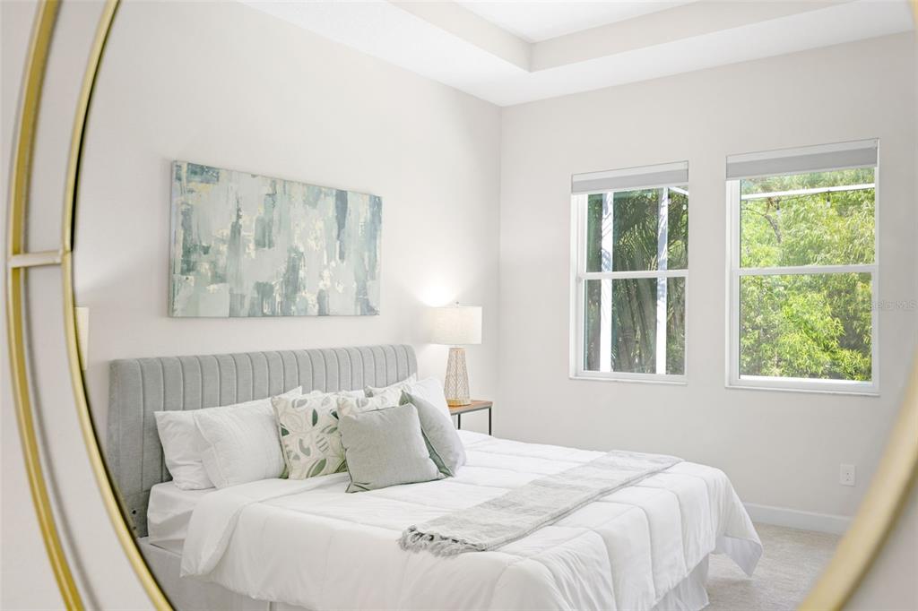 5116 Coastal Scene Drive Apollo Beach, FL 33572 - Photo 19 of 36 a bed sitting in a bedroom next to a window