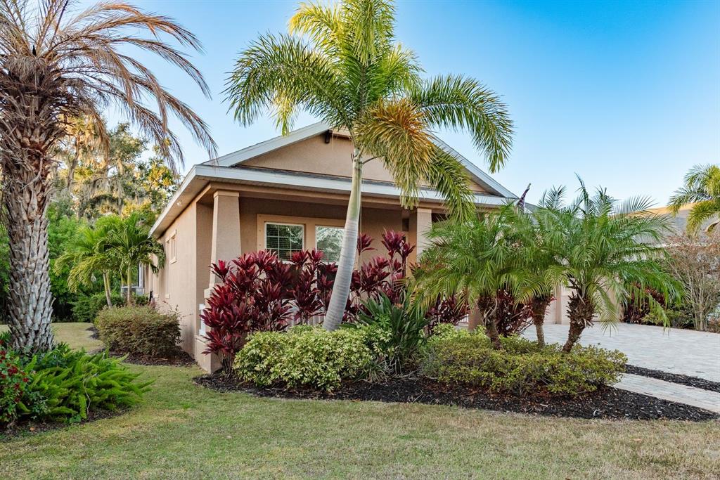 5116 Coastal Scene Drive Apollo Beach, FL 33572 - Photo 2 of 36 a front view of a house with a garden