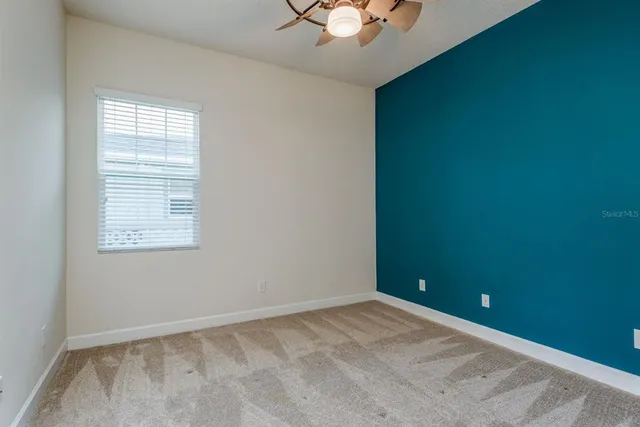 an empty room with closet and a bathroom