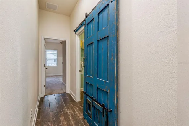 a view of a porch with furniture and floor to ceiling window