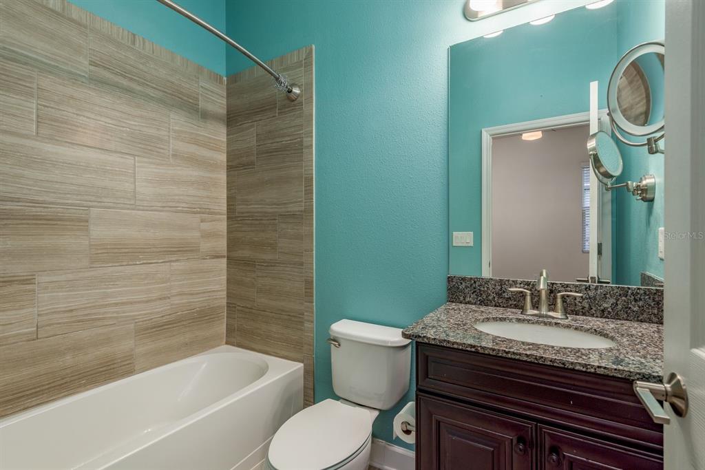 5116 Coastal Scene Drive Apollo Beach, FL 33572 - Photo 26 of 36 a bathroom with a granite countertop sink toilet and shower