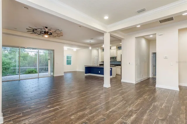 a view of an entryway with wooden floor and a kitchen