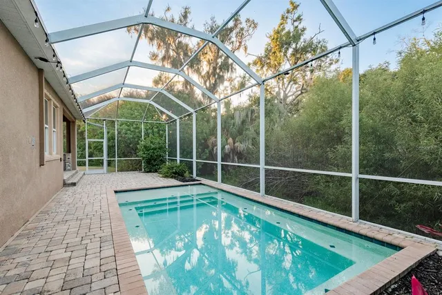 front view of a house with a yard and palm trees