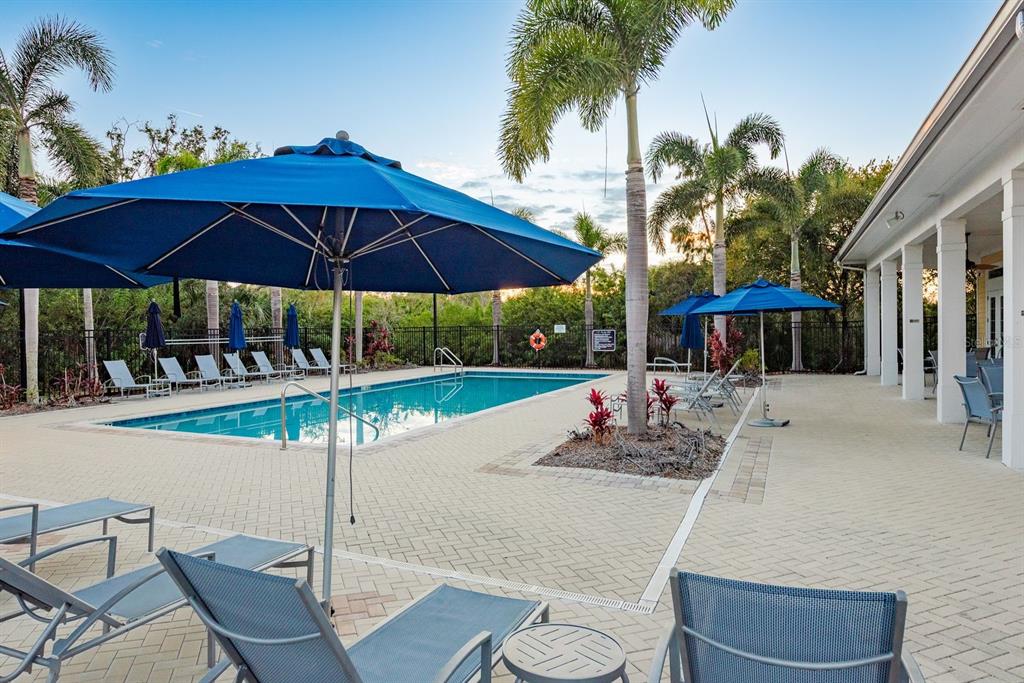 5116 Coastal Scene Drive Apollo Beach, FL 33572 - Photo 36 of 36 a view of a table and chairs under an umbrella