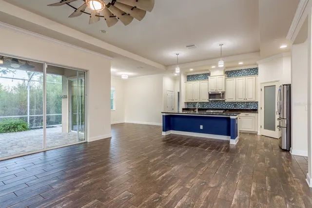 a view of kitchen with refrigerator microwave and stove