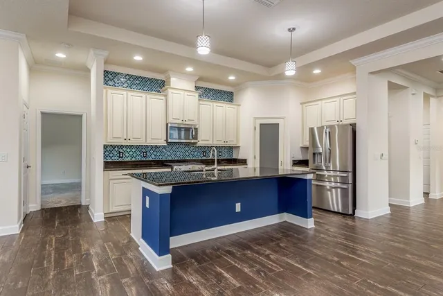a kitchen with stainless steel appliances granite countertop a sink stove and refrigerator