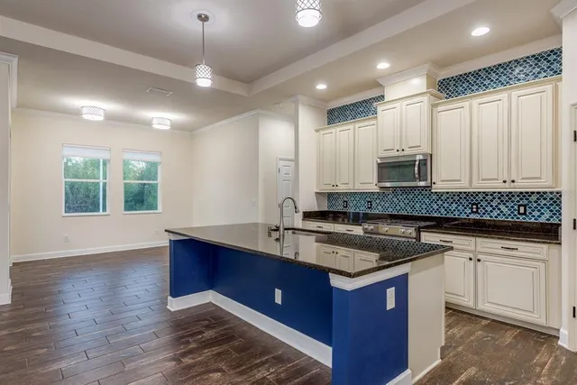 a kitchen with stainless steel appliances a refrigerator and cabinets