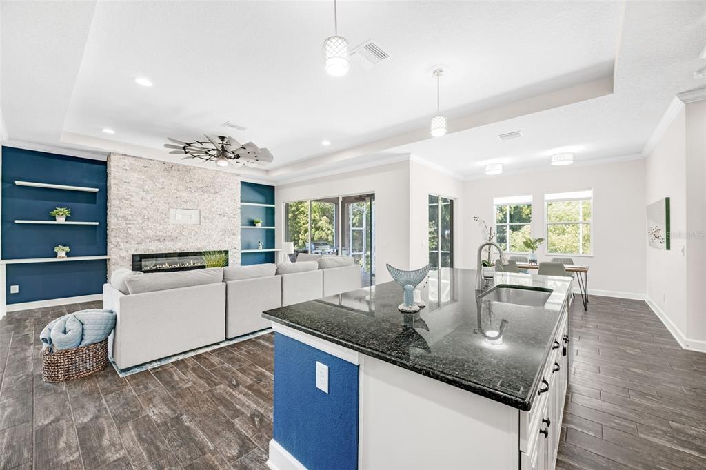 5116 Coastal Scene Drive Apollo Beach, FL 33572 - Photo 10 of 36 a kitchen with kitchen island granite countertop a sink appliances and cabinets