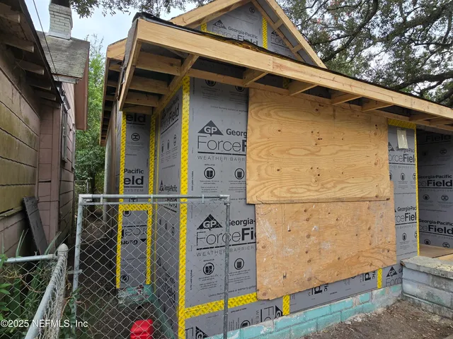 a view of a wooden door and brick wall