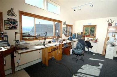 318 Strohm Circle Gypsum, CO 81637 - Photo 6 of 6 a room with lots of wooden furniture and a large window