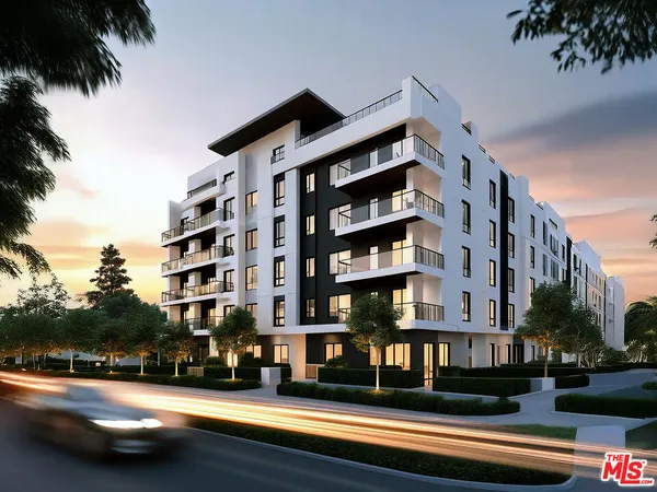 a front view of a building with street view and trees