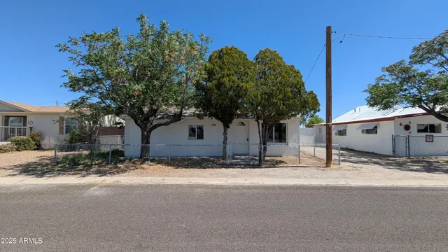 a tree in front of a house