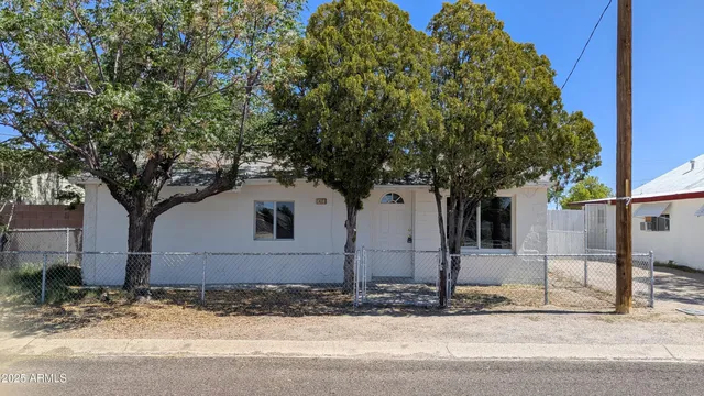 a house that has a tree in front of it