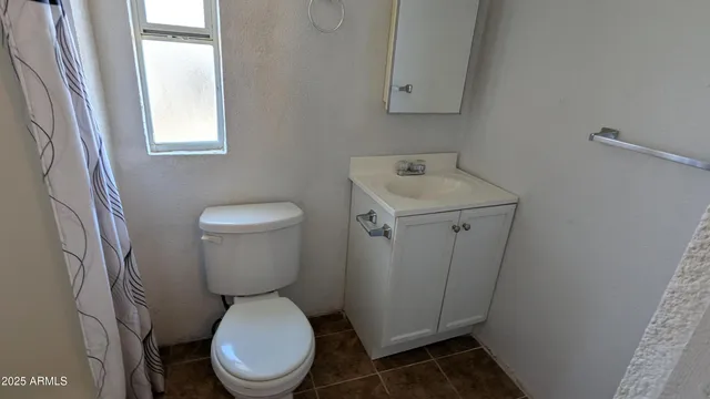 a white toilet sitting next to a bathroom sink