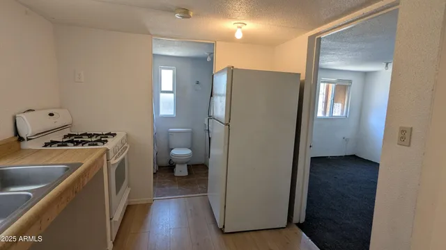 a kitchen with a refrigerator and a stove