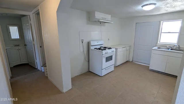 a kitchen with a stove and a refrigerator