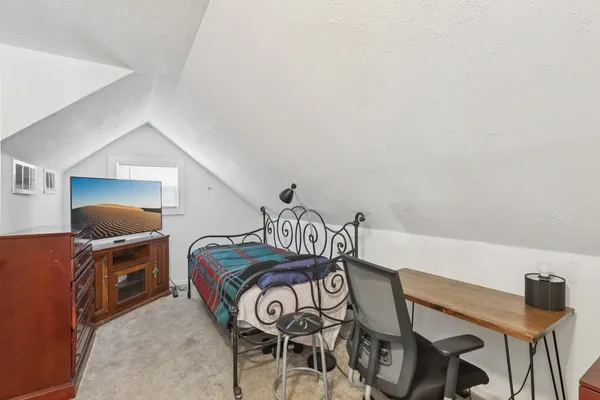 a bedroom with a bed and a couch
