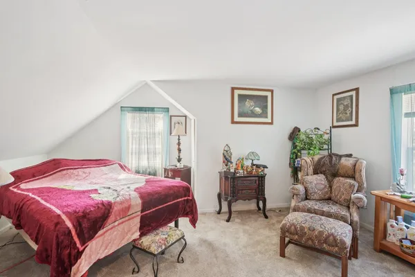 a bedroom with furniture and a chandelier