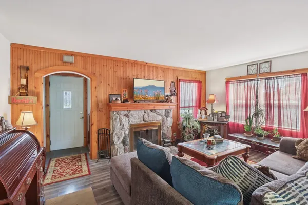 a living room with furniture a fireplace and a table