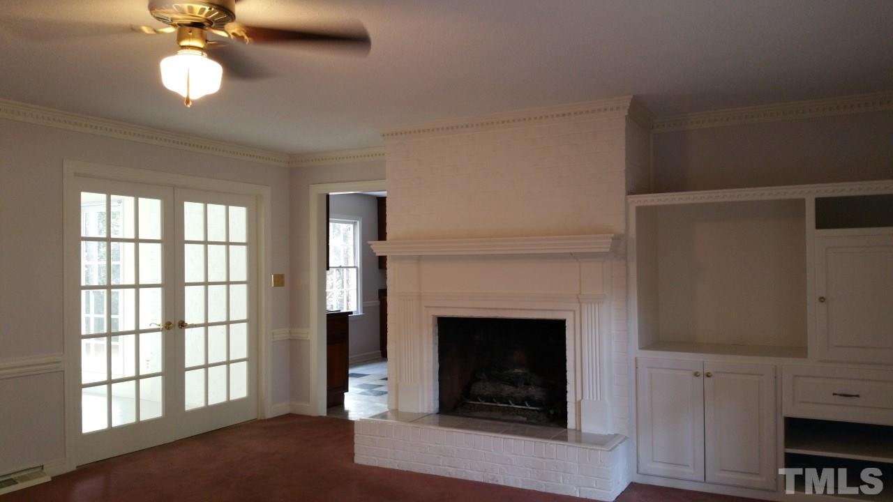 3805 Oak Park Road Raleigh, NC 27612 - Photo 2 of 20 a living room with furniture and a fireplace