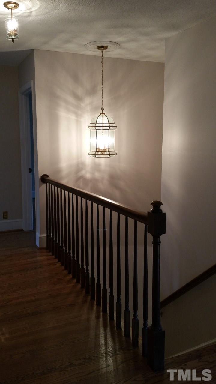 3805 Oak Park Road Raleigh, NC 27612 - Photo 11 of 20 a view of a hallway with wooden floor and staircase