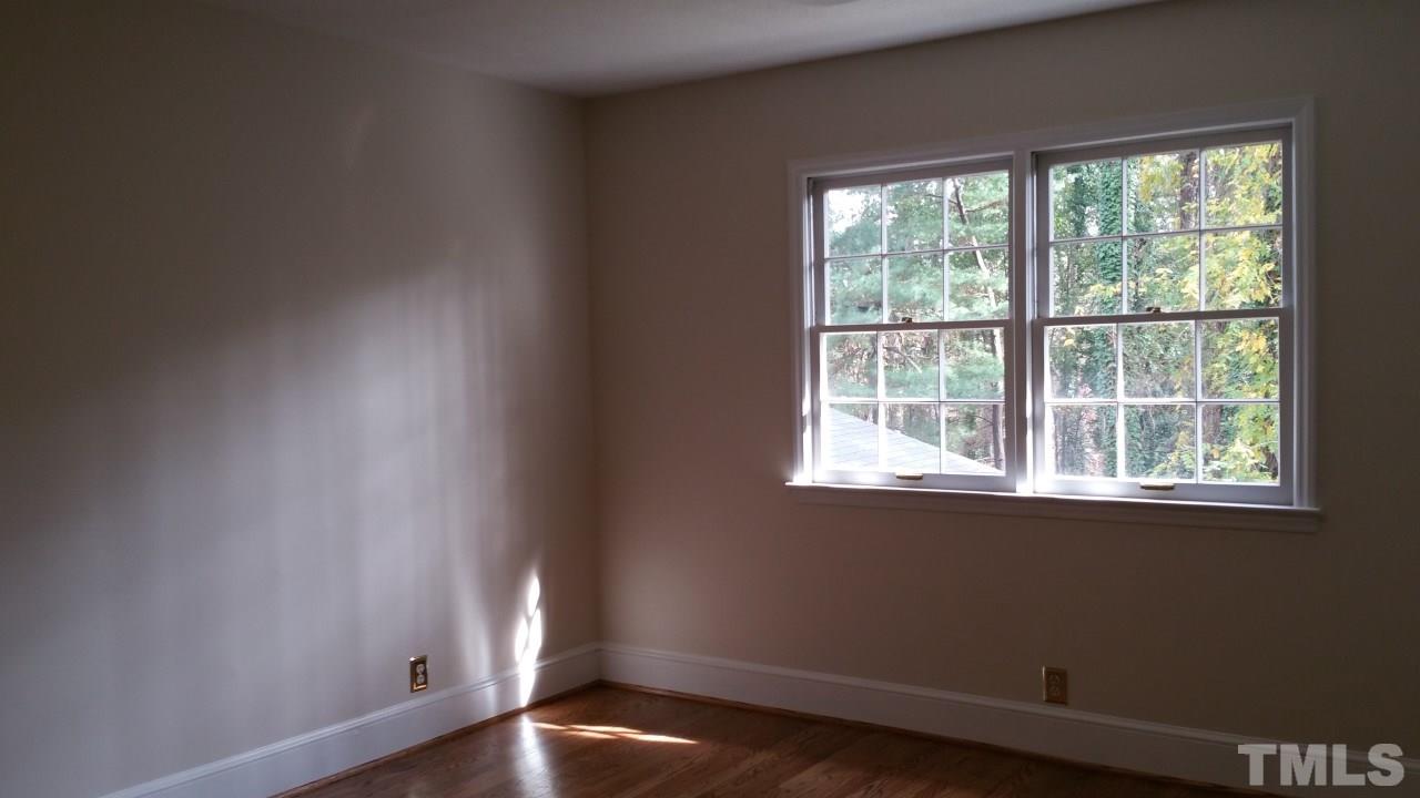 3805 Oak Park Road Raleigh, NC 27612 - Photo 12 of 20 an empty room with wooden floor and windows