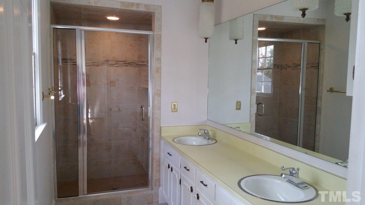 3805 Oak Park Road Raleigh, NC 27612 - Photo 13 of 20 a bathroom with a sink and a mirror