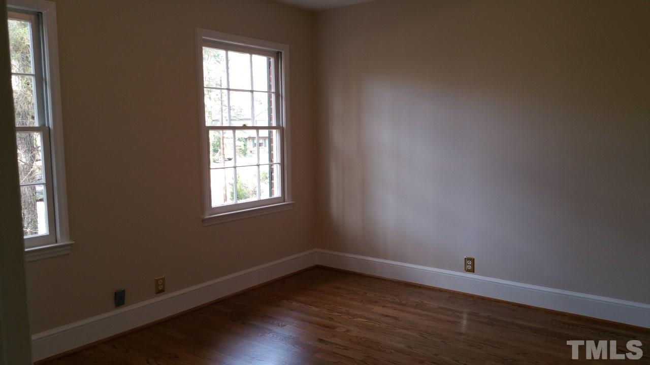 3805 Oak Park Road Raleigh, NC 27612 - Photo 15 of 20 an empty room with wooden floor and windows