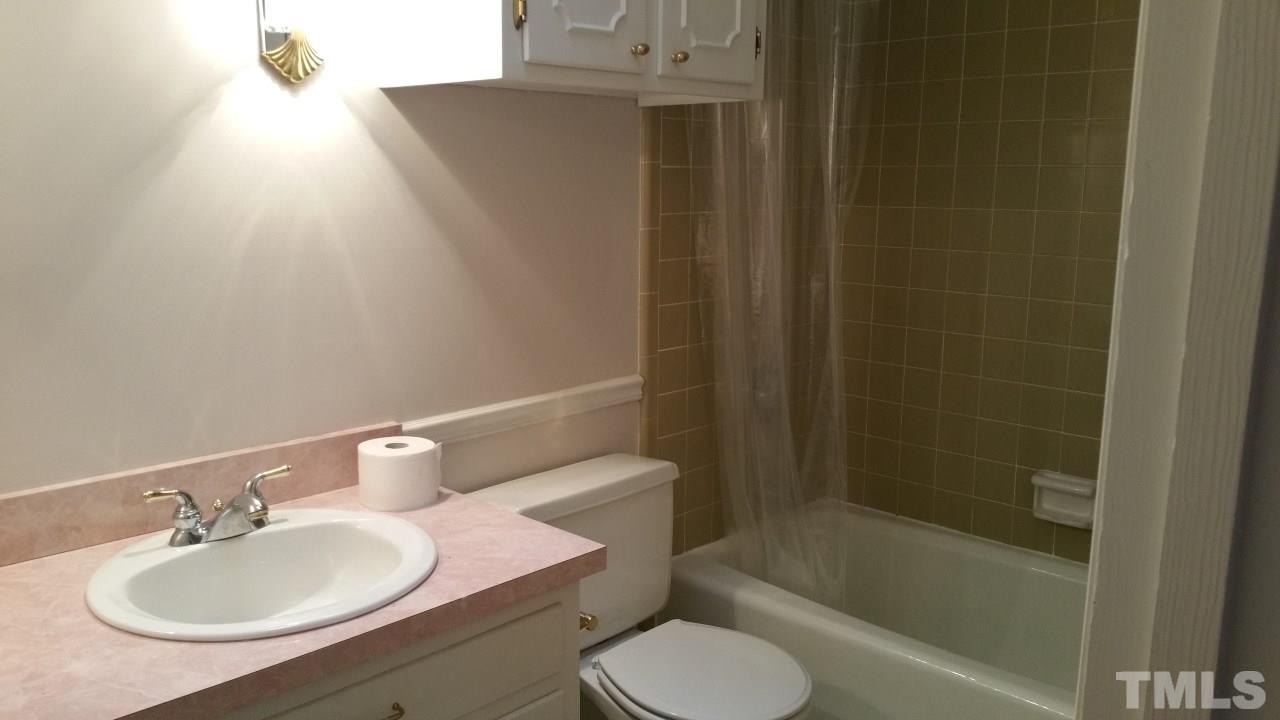 3805 Oak Park Road Raleigh, NC 27612 - Photo 16 of 20 a bathroom with a sink toilet and shower