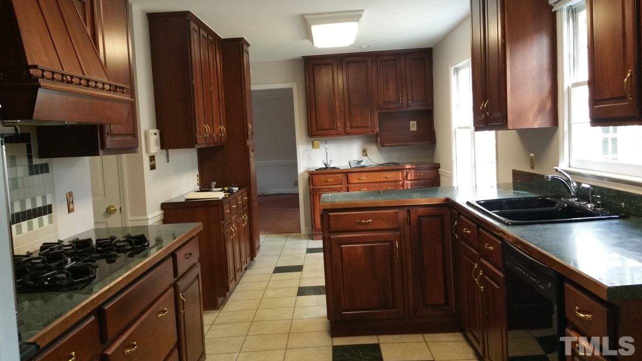3805 Oak Park Road Raleigh, NC 27612 - Photo 3 of 20 a kitchen with stainless steel appliances granite countertop a stove top oven a sink and dishwasher