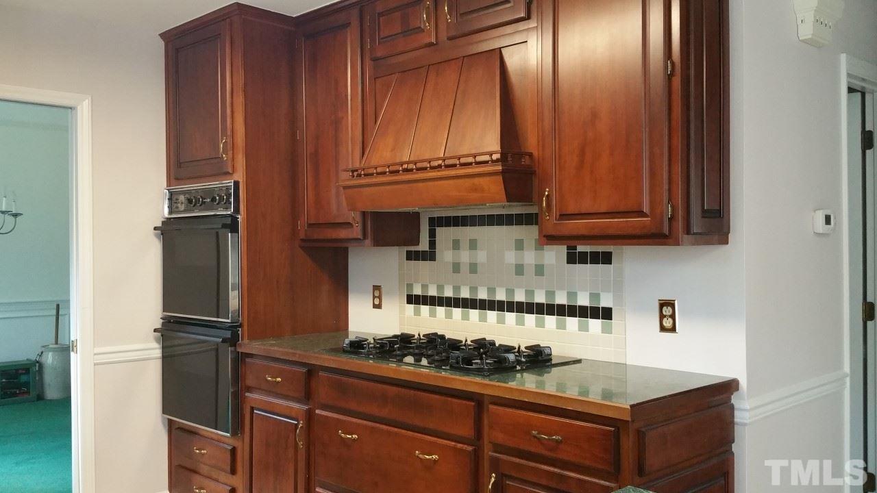 3805 Oak Park Road Raleigh, NC 27612 - Photo 4 of 20 a kitchen with granite countertop cabinets and stainless steel appliances