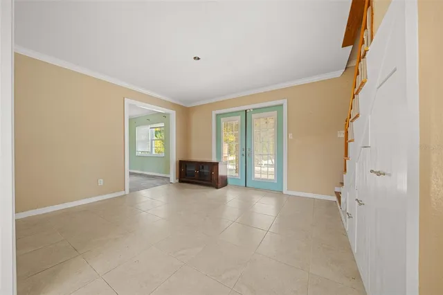 a view of an empty room with window and fireplace