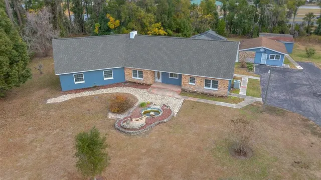 an aerial view of a house with outdoor space