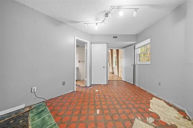 a view of a hallway with wooden floor and stairs