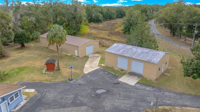 an aerial view of a house with a yard
