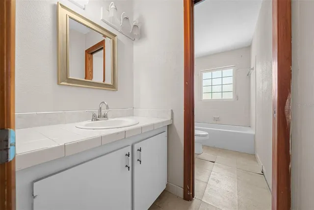 a bathroom with a toilet and a bath tub