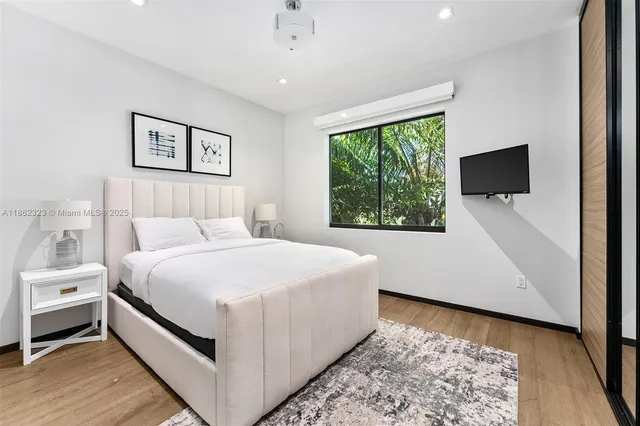 a large white bed in a white room