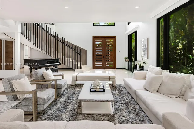 a living room with furniture and large rug