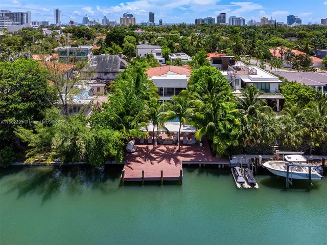 a aerial view of a house with a garden and lake view