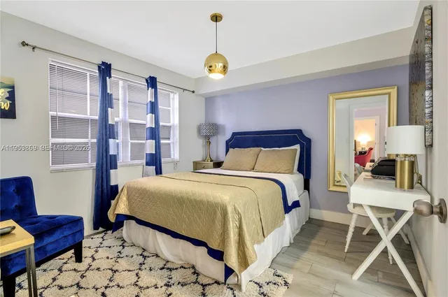 a bedroom with a bed a couch and potted plant