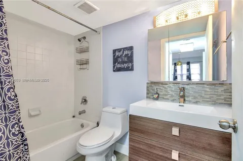 a bathroom with a sink a toilet and a bathtub