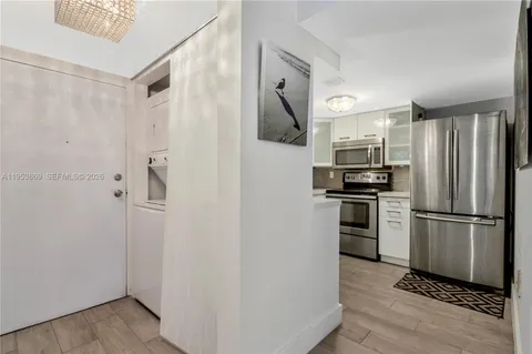 a kitchen with stainless steel appliances a refrigerator and a stove top oven