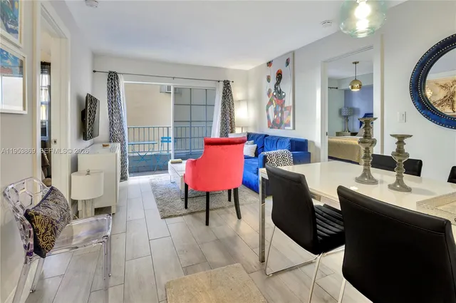 a living room with furniture a flat screen tv and a large window