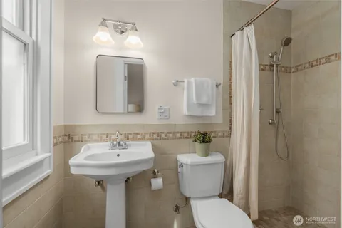 a bathroom with a toilet sink and mirror