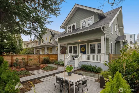 a front view of a house with garden and patio