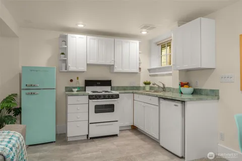 a kitchen with stainless steel appliances granite countertop a sink and a refrigerator