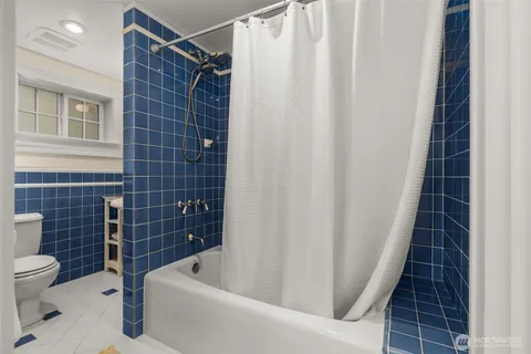 a bathroom with a bathtub a toilet a sink and a shower